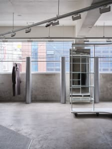 An industrial interior space with metallic lighting fixtures and minimalist design elements.