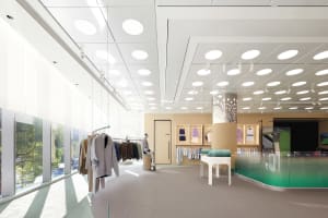 A minimalist interior design of a white concrete clothing boutique with modern clothing racks.