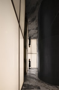 A minimalist interior design featuring marble and glass panels