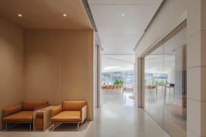 A modern lobby area featuring wood-paneled walls and leather seating.