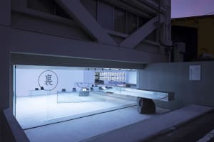 A minimalist retail space featuring modern concrete and glass materials.