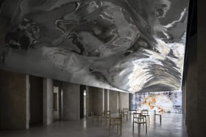 Modern lobby with marble walls and concrete ceiling