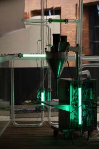 Industrial machinery with green tubing and metal components