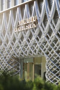 A modern building exterior made of metal with intricate lattice design.