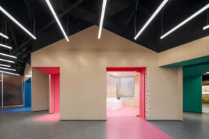 A modern classroom entrance with colorful accents and concrete materials.