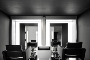 A modern salon interior featuring black cabinets and sleek, minimalist design.