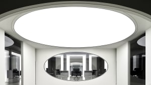 An interior design of a modern office space featuring glass walls and a sleek, contemporary design.