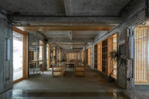 Industrial-style office space with concrete and wooden elements.