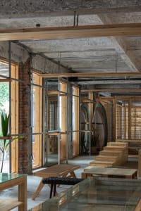 Modern minimalist interior design of a shop featuring wooden elements and clean, simple lines.
