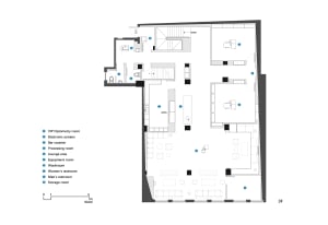 Floor plan of a modern commercial interior with various functional spaces labeled and detailed.