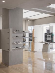 Interior of a retail space featuring granite display shelves showcasing sunglasses.