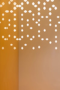 A minimalist interior design featuring textured plywood with geometric cutouts.