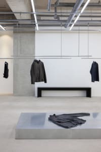 Modern clothing display with metal surfaces and minimalist design.