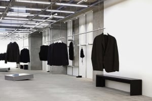 Modern retail space featuring concrete walls and metal railings.