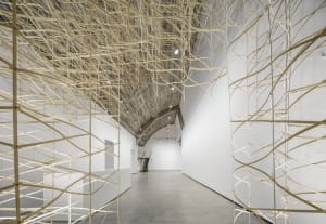 An interior space featuring minimalist design elements made of metal and glass materials.