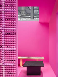 A minimalist interior space featuring pink cards.