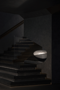 Modern staircase with minimalist design, featuring concrete steps and a glass railing.