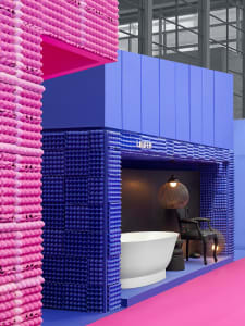 A modern bathroom with white ceramic tiles and glass elements.