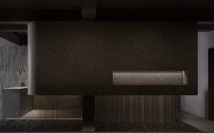 A modern lobby interior with a concrete wall and floor, featuring a minimalist design.