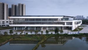 A modern building featuring concrete and glass materials with a minimalist design.