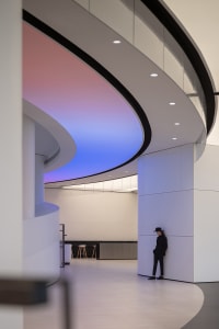 A modern interior space with glass ceiling and sleek design elements.