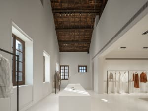 Modern retail store with minimalist design and white painted walls and ceiling.