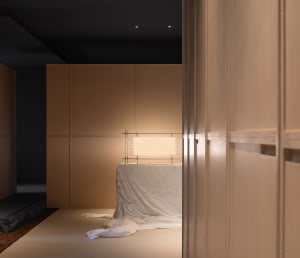 A minimalist interior design with wooden paneling, a light source, and white cloth on the floor.