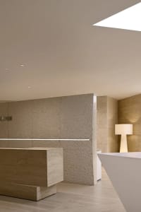 Minimalist interior design with concrete walls and floor, featuring clean lines and a modern aesthetic.