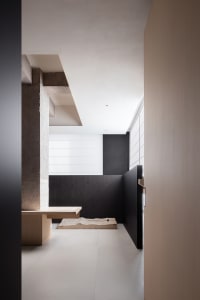 Modern interior design featuring concrete, wood, and stone elements.