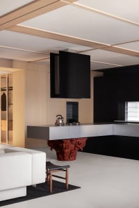 A modern kitchen with wooden finishes and black accents.