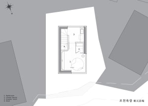 Concrete bathroom suite floor plan with a circular soaking tub and adjacent powder room.