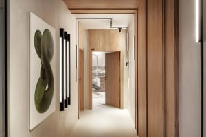 A minimalist office interior with wooden walls and white surfaces.