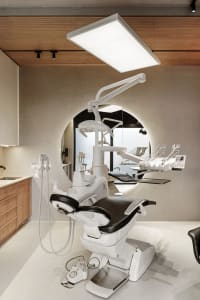 Modern, industrial-style dental office with metallic finishes.