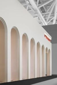 Neutral-colored retail interior with arches and lighting pipes