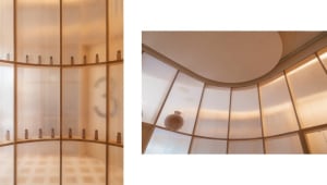 A modern storefront display featuring glass and brass elements.
