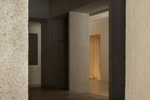 Modern minimalist interior with concrete walls and floor.