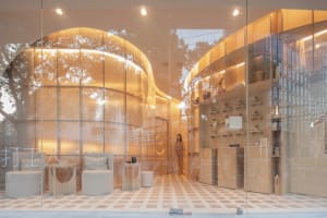 A modern retail storefront with glass walls and interior design features