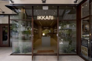 Ikari restaurant storefront with glass walls and a neon sign reading 'IKKARI'.
