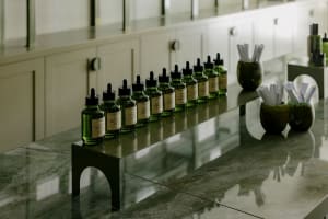 Industrial-style workplace with a row of green glass bottles.