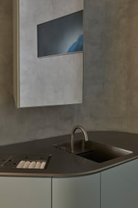 Modern kitchen featuring a concrete countertop and minimalist design.