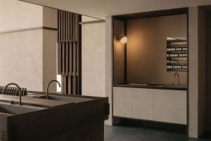 A minimalist spa interior featuring concrete and wood surfaces and a modern design aesthetic.