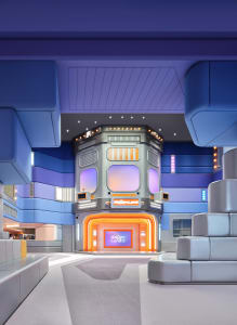 Modern kids playground with panel walls and concrete flooring, featuring colorful lighting.