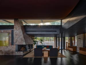 A modern living room with concrete walls and stone flooring.