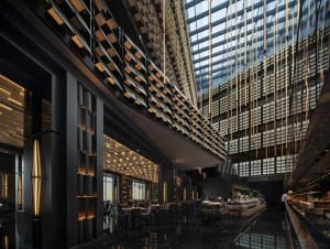 An industrial-style restaurant interior with modern design elements, featuring glass and metal materials, and contemporary li