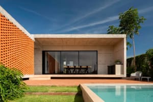 Modern building exterior with a concrete facade and a covered patio area.