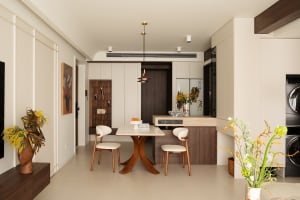 A minimalist residential kitchen featuring wooden elements, beige decor, and white finishes.