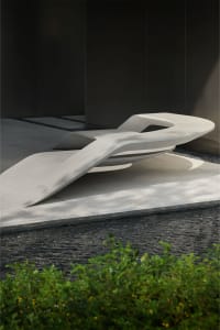 Modern bench with abstract, sculptural design in concrete material
