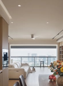 Modern interior design featuring a glass window and white leather sofa.