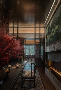 A modern dining room featuring wooden furniture, glass elements, and metal accents.