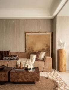 A modern living room with wooden furniture, including a sofa, coffee tables, and decorative items.